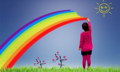 Little girl painting a rainbow on the sky - Joy and happiness in childhood